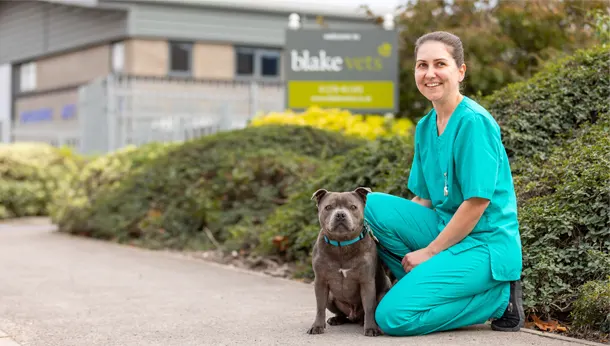 Nurse with dog outside Blake Vets